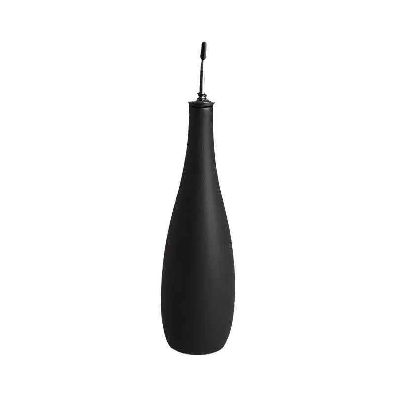 Ceramic oil pot with funnel lid and integrated brush in kitchen setting