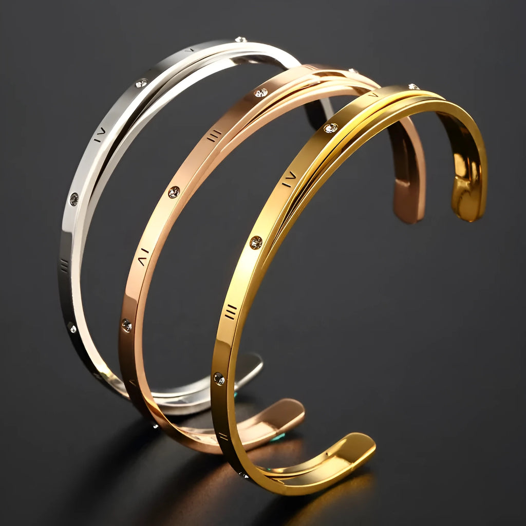 Open-ended stainless steel bracelet for women with inlaid zircon stones, shown in gold colour.