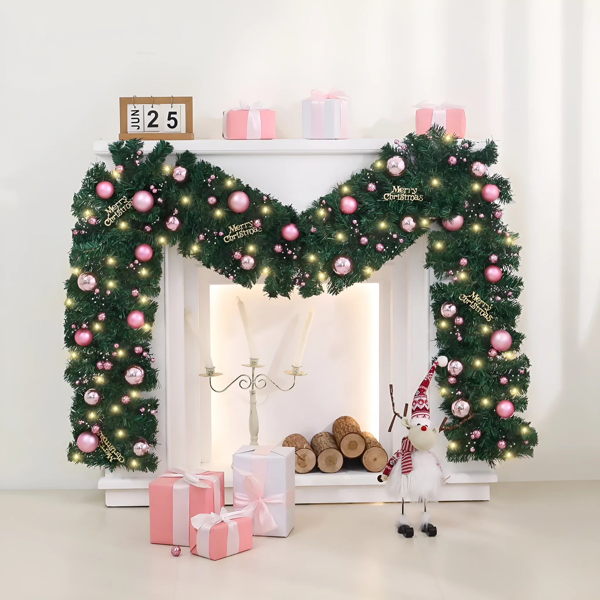 Pink artificial Christmas rattan garland with small berries and warm white LED lights draped on a mantelpiece.