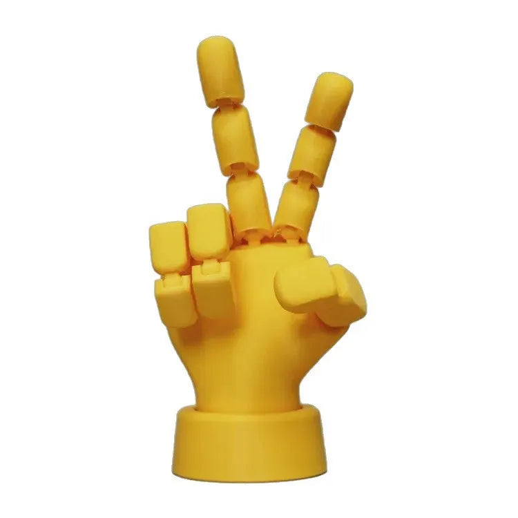 Yellow movable joint hand prop ornament with articulated fingers on white background