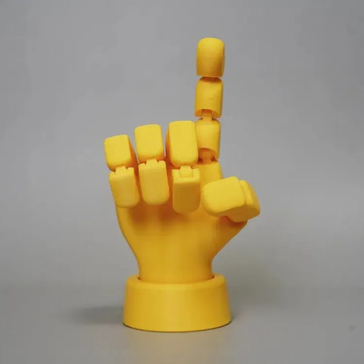 Yellow movable joint hand prop ornament with articulated fingers on white background