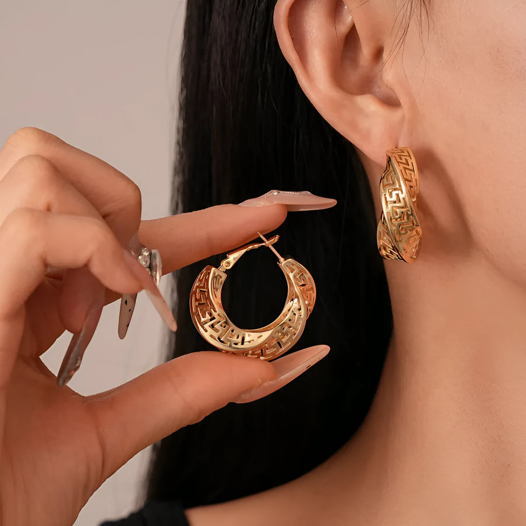 Women's twisted geometric hollow stud earrings in gold and silver electroplated finishes