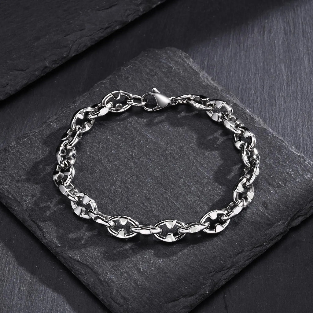 Men's stainless steel geometric link chain bracelet showing thick handmade construction