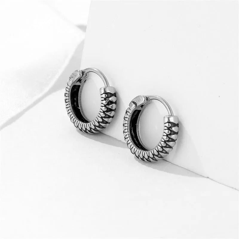 Silver geometric striped drop earrings with retro twist design and round sports-style elements
