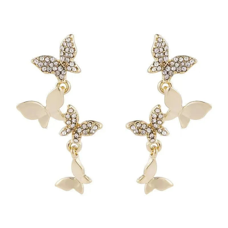 Women's copper butterfly drop earrings with four motifs in gold colour