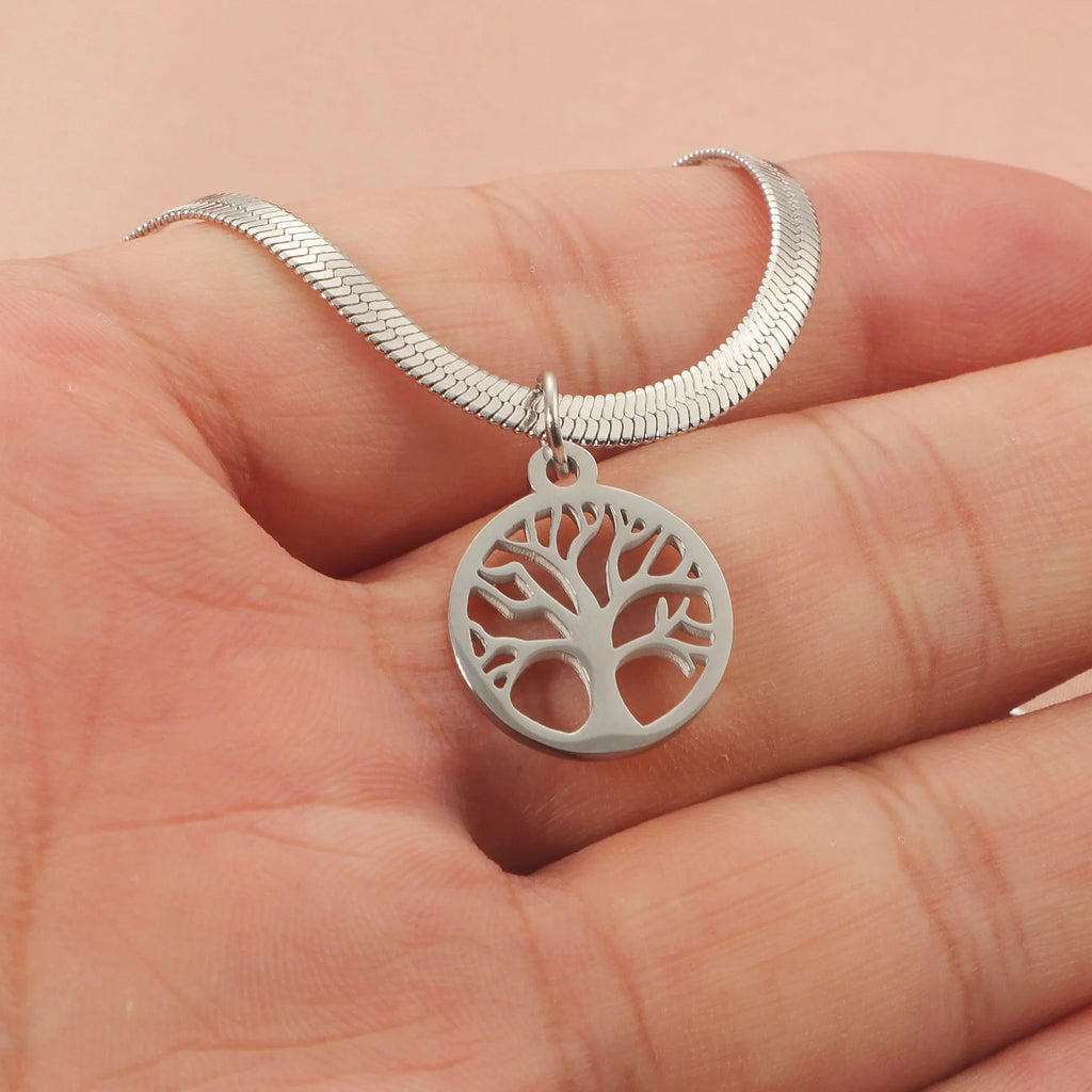 Gold tone lucky tree pendant necklace on a textured snake chain against a plain background.