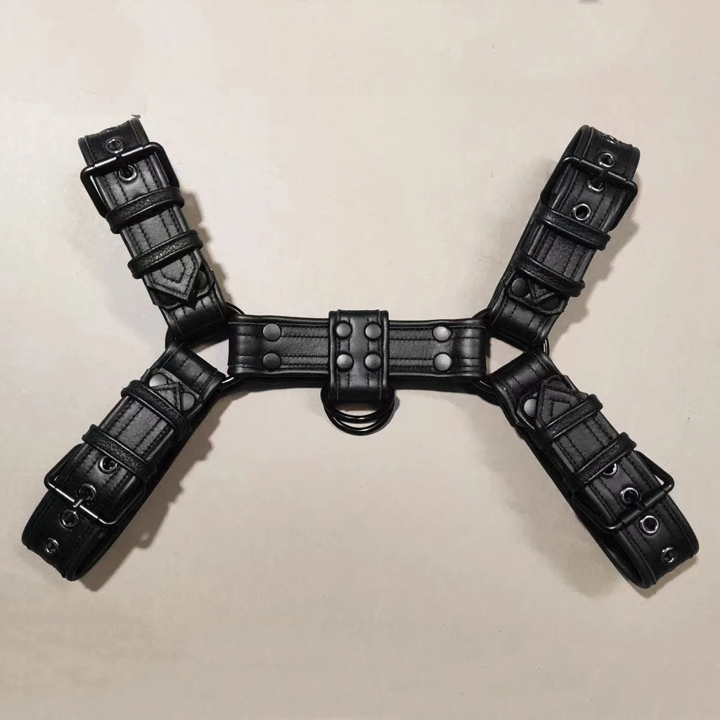 Black leather chest muscle bondage strap with metal buckle and rivet details