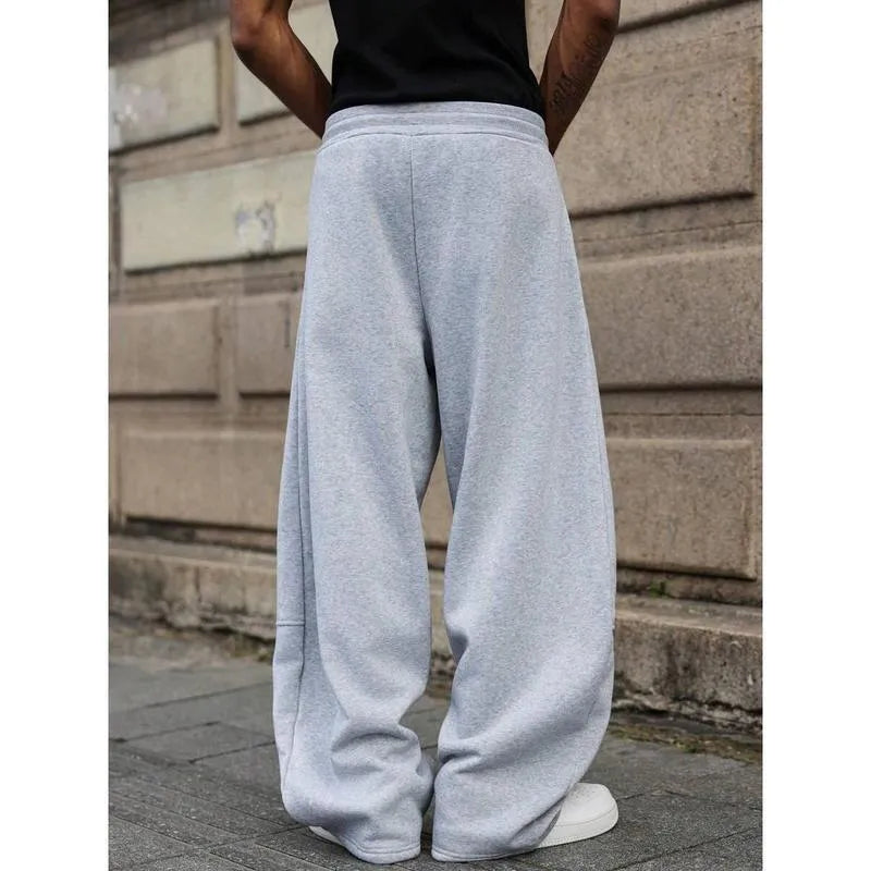 Man wearing dark grey high-waist straight-leg casual trousers made from elastic bamboo fibre fabric.