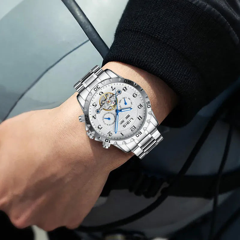 Men's silver stainless steel automatic perpetual calendar mechanical watch on wrist.