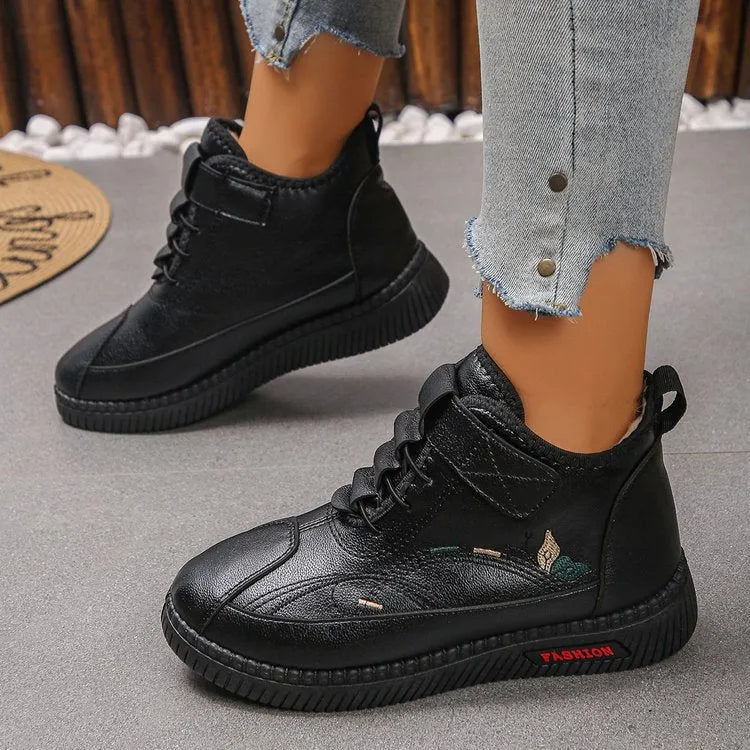 Women's black velvet slipper with hollow-out design and non-slip rubber sole.
