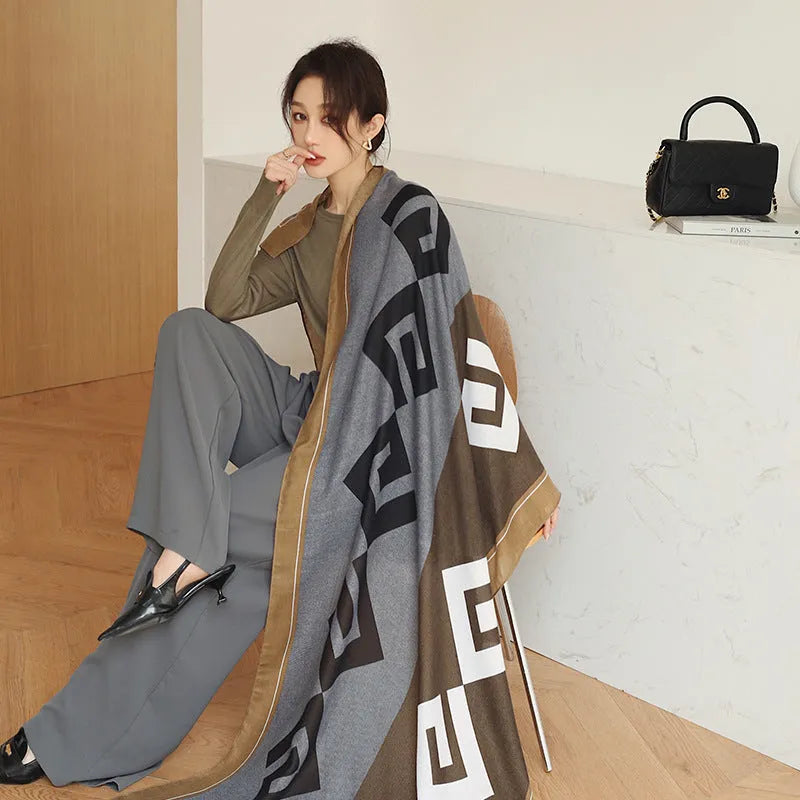 A woman wearing a printed polyester shawl measuring 180cm by 90cm.