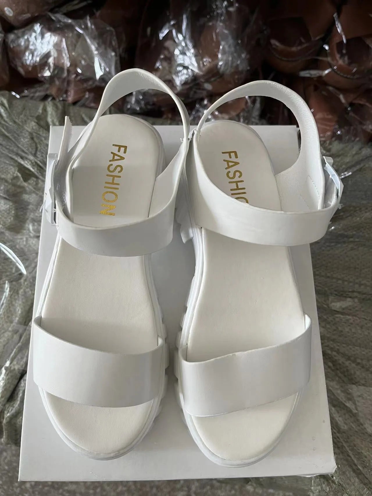 Beige women's platform sandals with peep toe and ankle strap buckle on a white background.