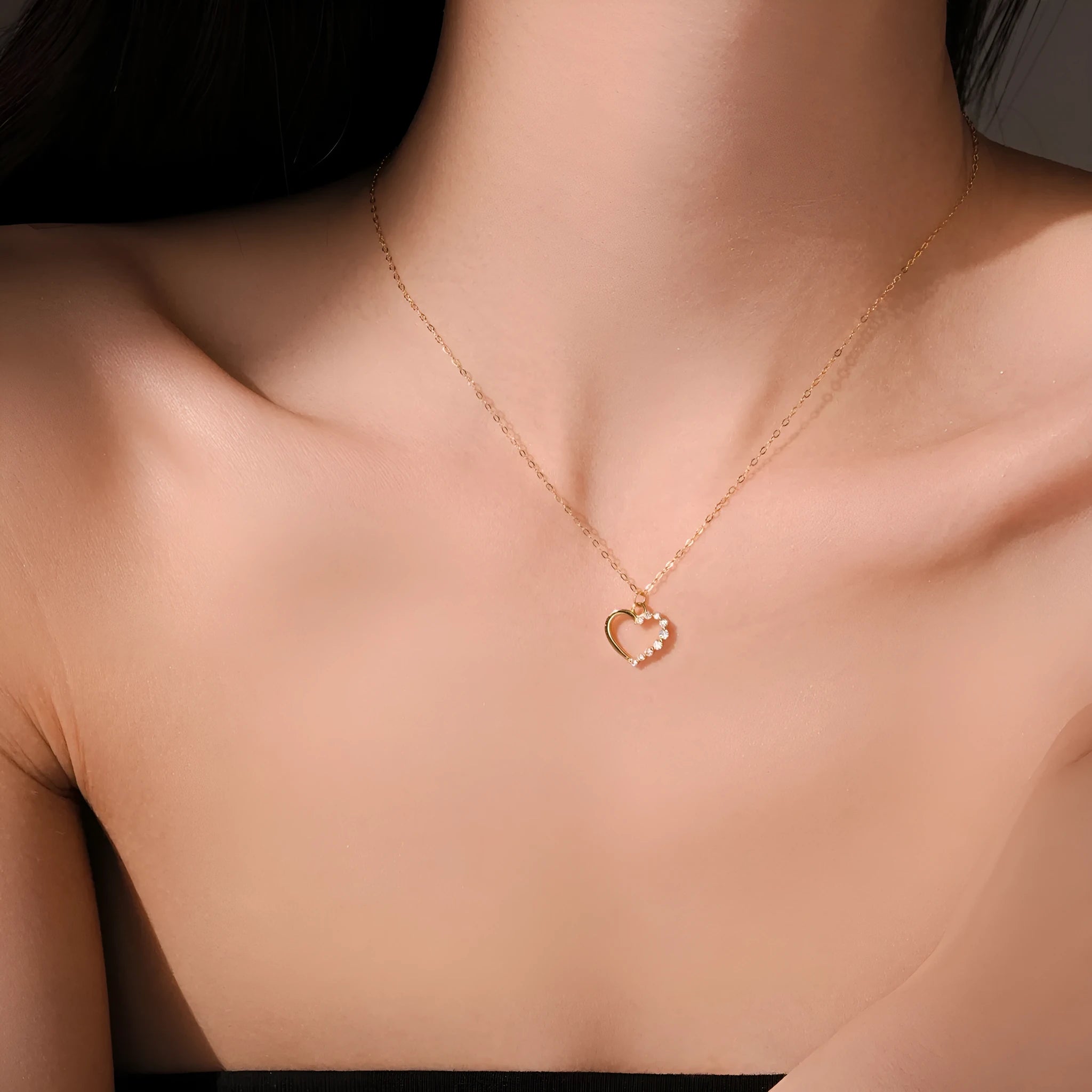 Sterling silver hollow heart pendant necklace on a classic chain, available in white gold or 18K gold plating.