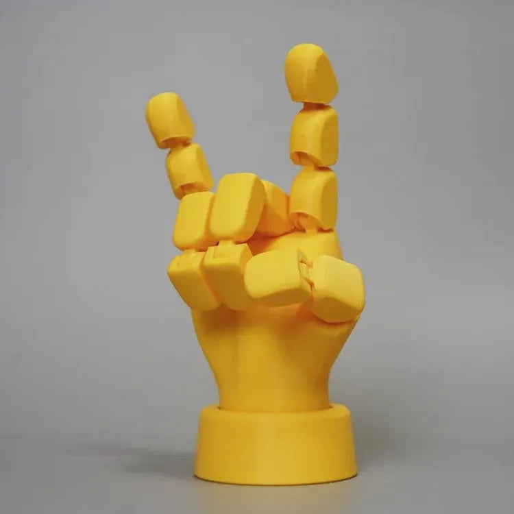Yellow movable joint hand prop ornament with articulated fingers on white background