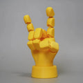 Yellow movable joint hand prop ornament with articulated fingers on white background