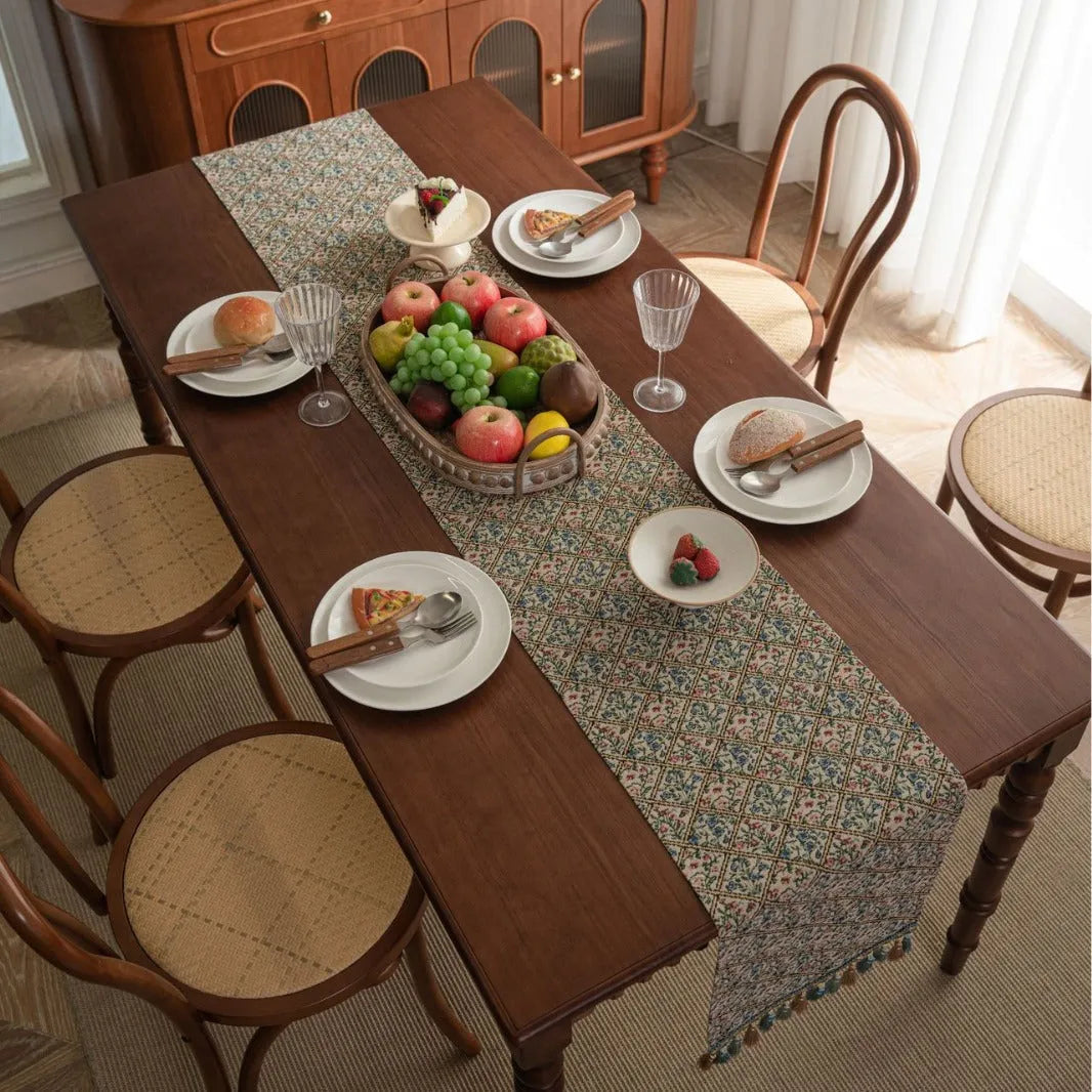Dark blue Nordic Jacquard bouquet pattern table runner with tassel trim, 32cm wide.