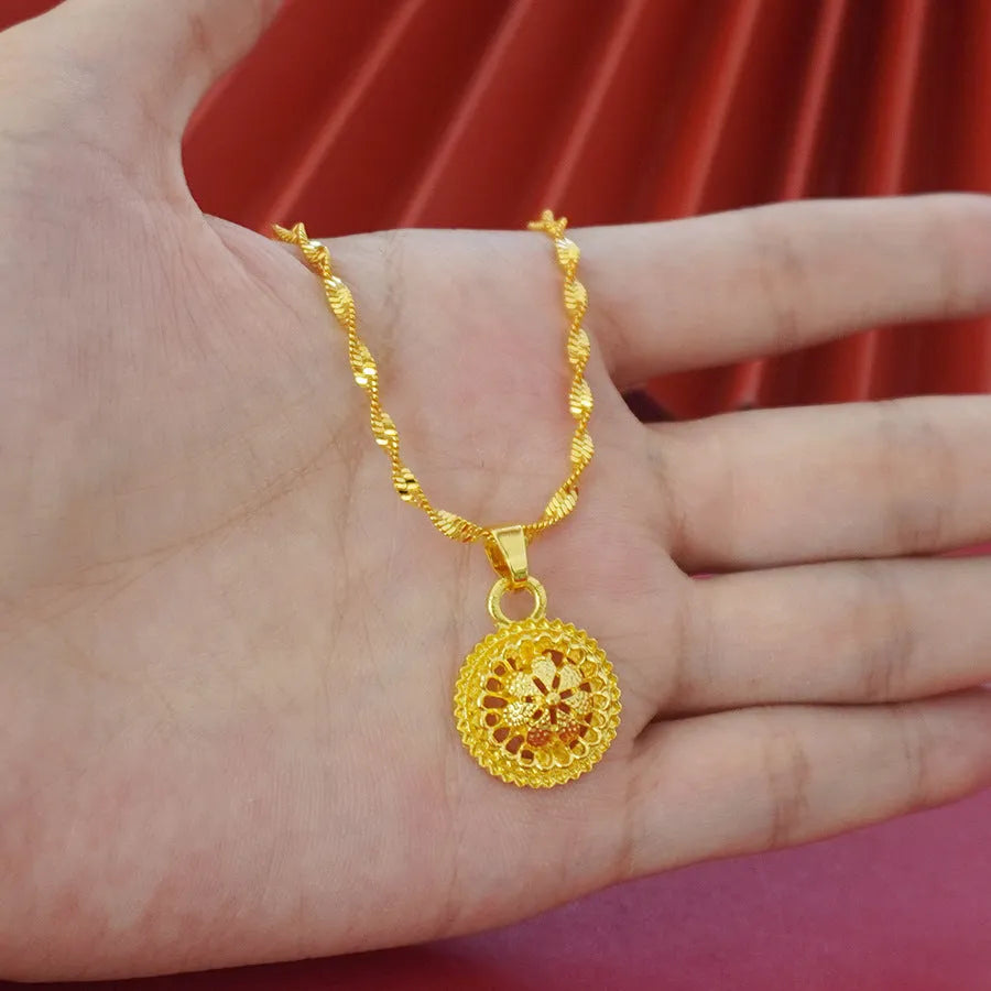Gold-plated three-piece jewellery set with floral designs including necklace, earrings, and ring