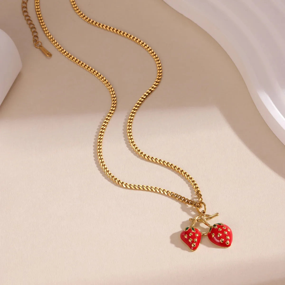 Stainless steel strawberry pendant necklace with red and white gradient colour finish.