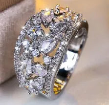 Women's round hollow copper fashion ring showing open design with metal plating and coloured accent options