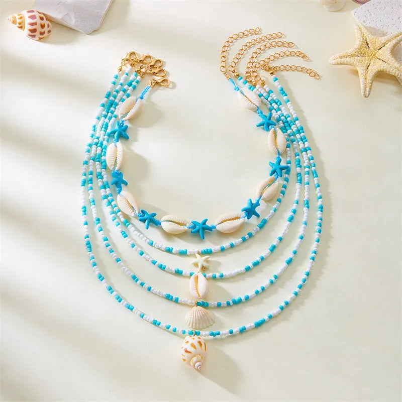 Five women's necklaces with starfish, shell and conch bead pendants on adjustable chains