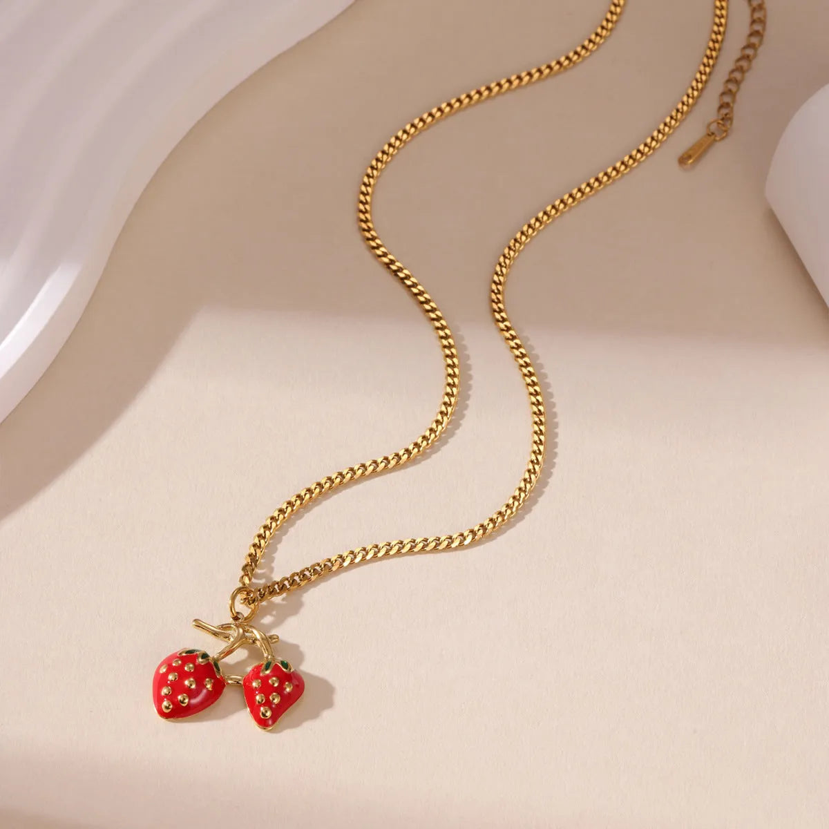 Stainless steel strawberry pendant necklace with red and white gradient colour finish.