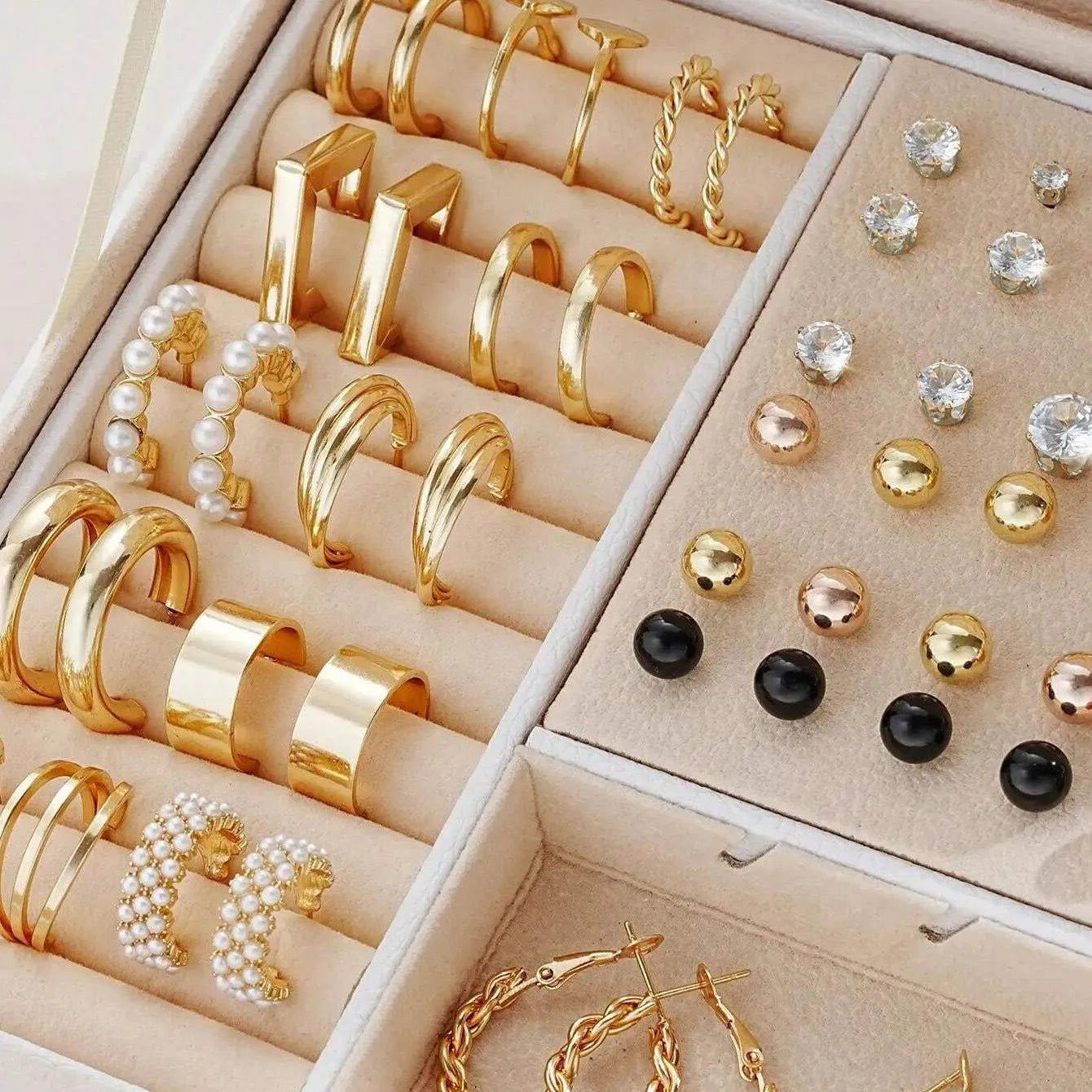 108 gold and yellow alloy stud earrings with geometric shapes and round pearl details on a plain surface.