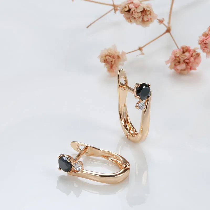 Women's drop shape earrings with black agate stones and gold-plated copper geometric design