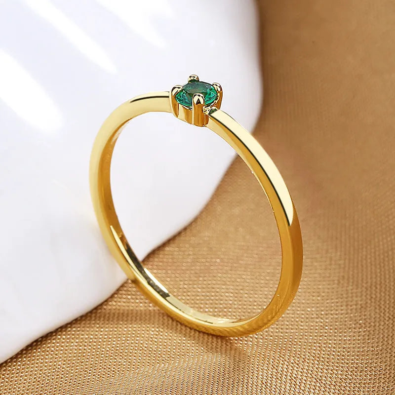 Copper geometric ring with a single diamond shape on a round band, shown in white, red, green, and blue colour options.