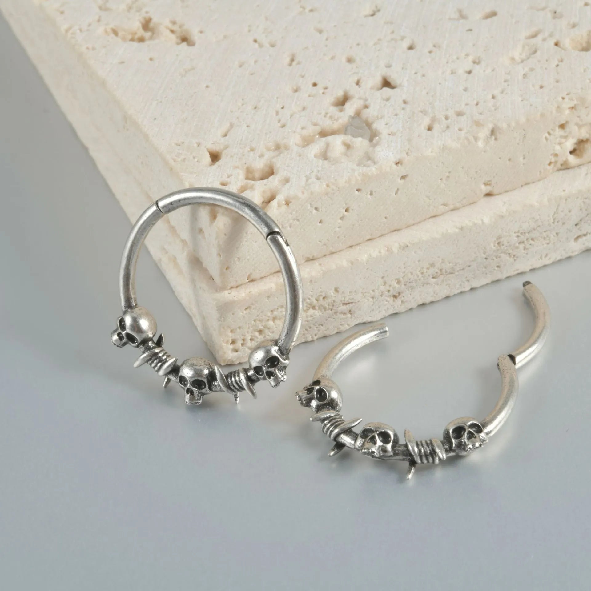 Copper punk earring with detailed ghost head design in antique silver finish for pierced ears