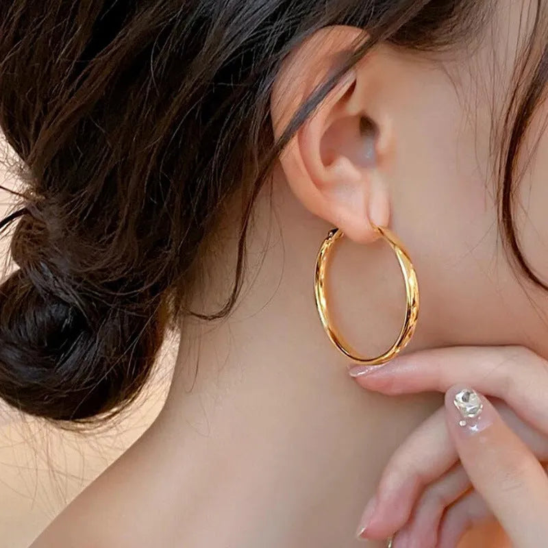 40mm circular metal earrings with electroplated gold or silver finish on copper base