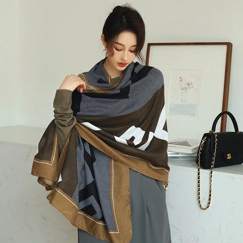 A woman wearing a printed polyester shawl measuring 180cm by 90cm.