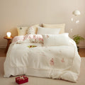 Milk fibre four-piece bedding set with green Christmas tree pattern showing fitted sheet, quilt cover and pillowcase