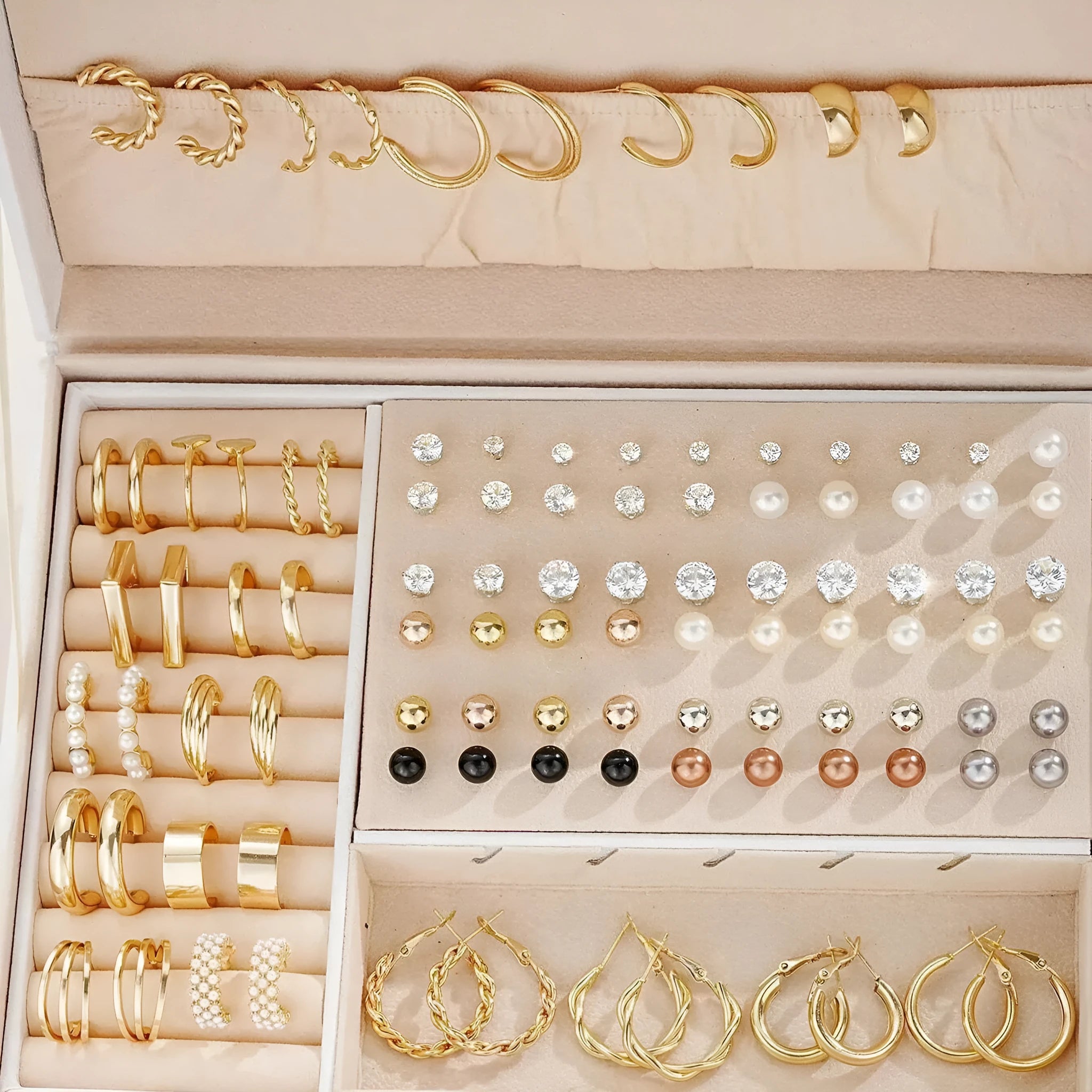 108 gold and yellow alloy stud earrings with geometric shapes and round pearl details on a plain surface.