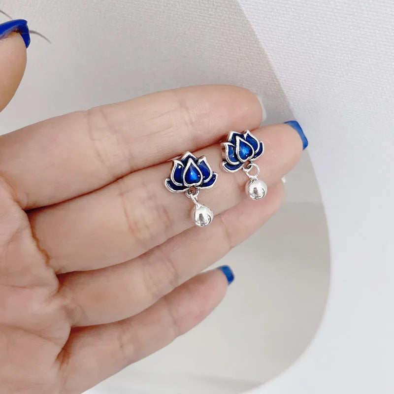 Blue alloy lotus seedpod earrings with tassel detail, shown as a pair of dangle drop studs.