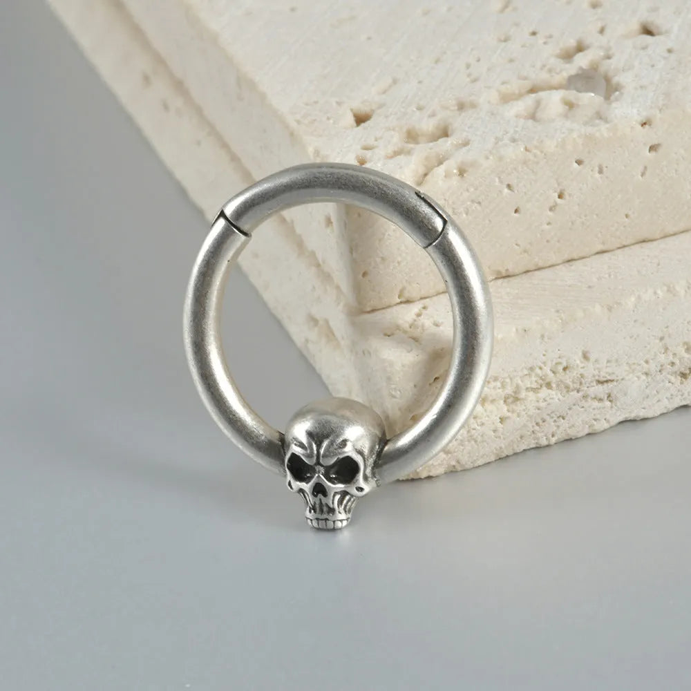 Copper punk earring with detailed ghost head design in antique silver finish for pierced ears