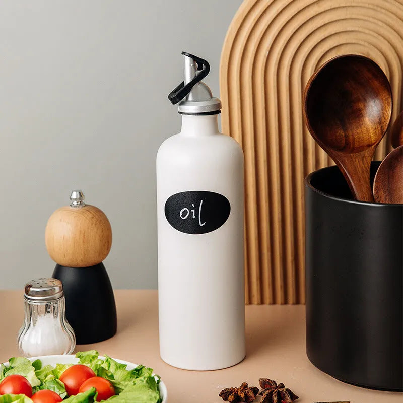 Ceramic oil pot with funnel lid and integrated brush in kitchen setting