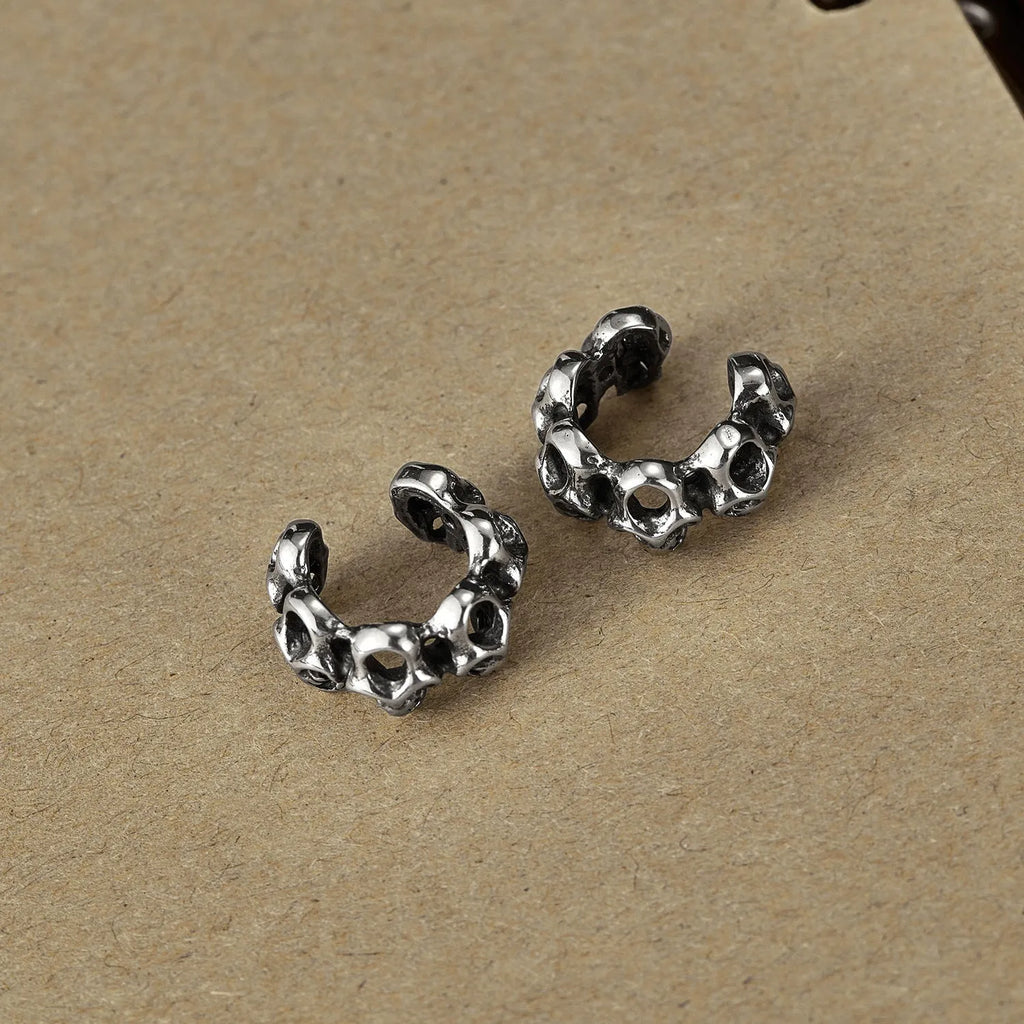Stainless steel skull ear clip earrings with hollow geometry design and electroplated finish