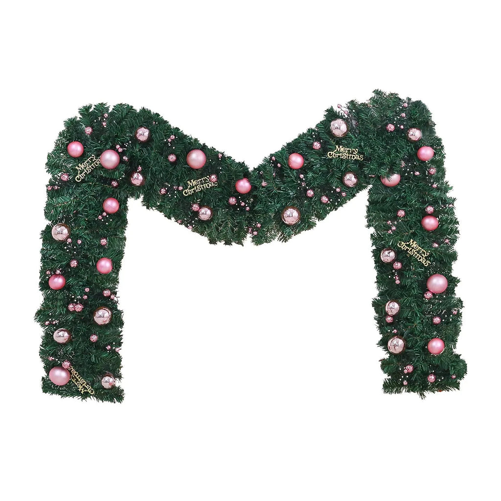Pink artificial Christmas rattan garland with small berries and warm white LED lights draped on a mantelpiece.