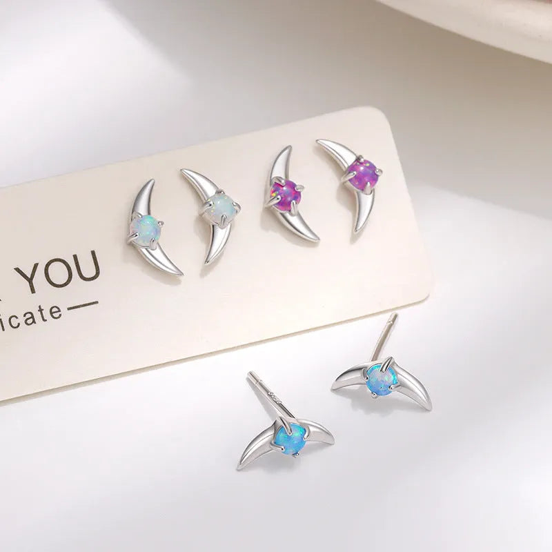 Geometric women's earrings in 925 silver with gold plating and a blue cubic zirconia stone.