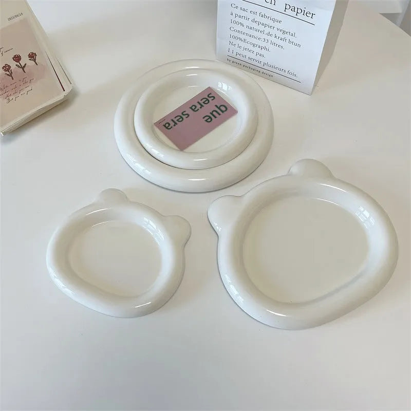 White ceramic plate with bear doodle design, 20cm diameter, on a table.