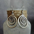 Silver geometric spiral earrings with distressed finish and vintage ethnic style design
