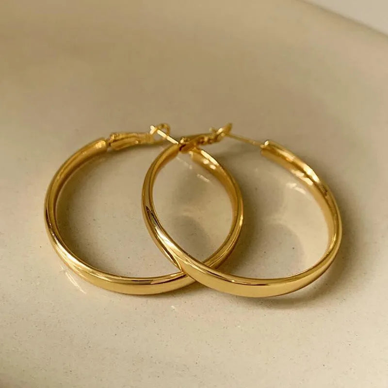 40mm circular metal earrings with electroplated gold or silver finish on copper base
