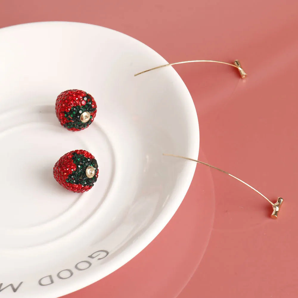 Geometric strawberry-shaped alloy earrings with spot-drill texture, shown in red colour.