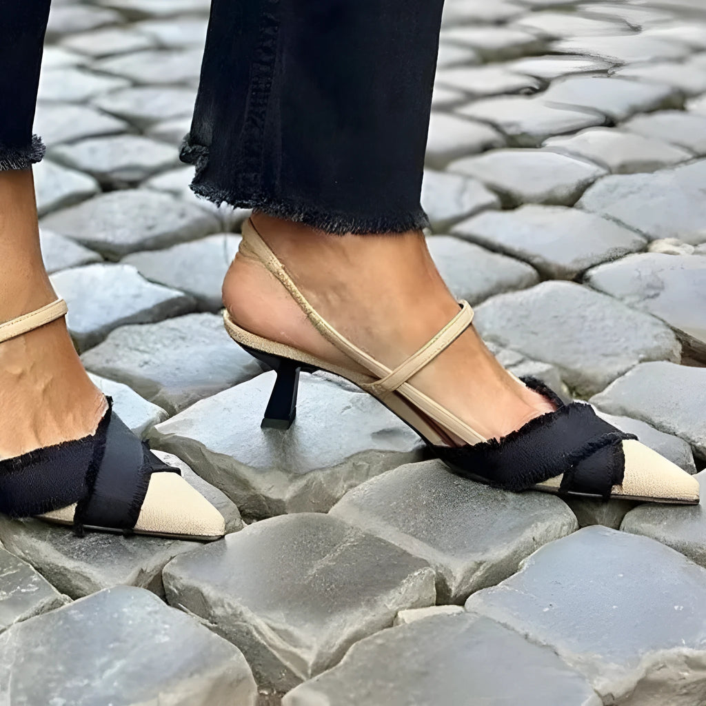 Women's apricot and black colour-block stiletto heel sandals with pointed toe and ankle buckle.