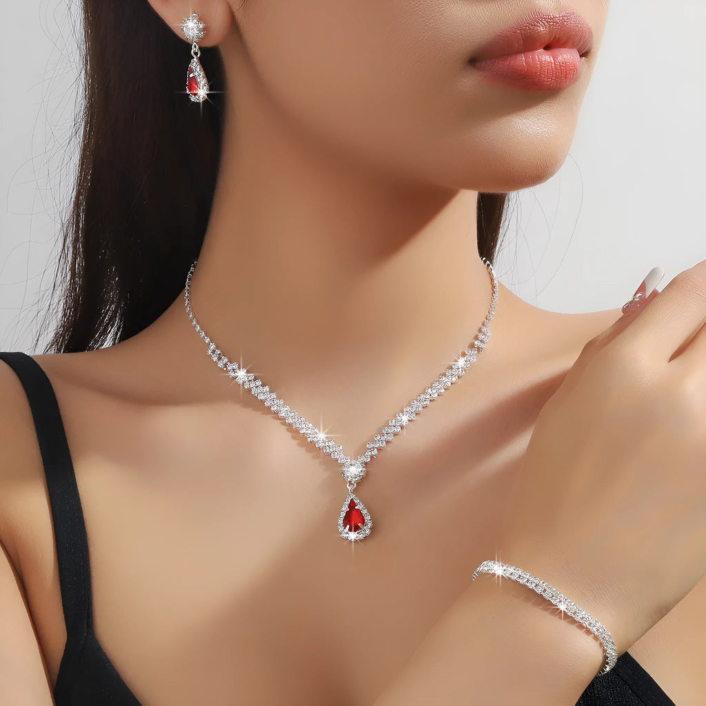 Women's rhinestone water drop necklace and earrings set on a claw chain in blue colour.