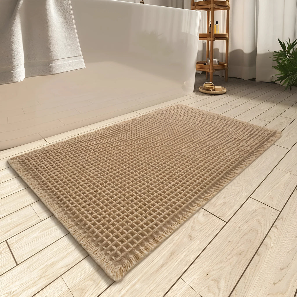 Square checkered polyester bathroom carpet on a tiled floor in a light grey colour.