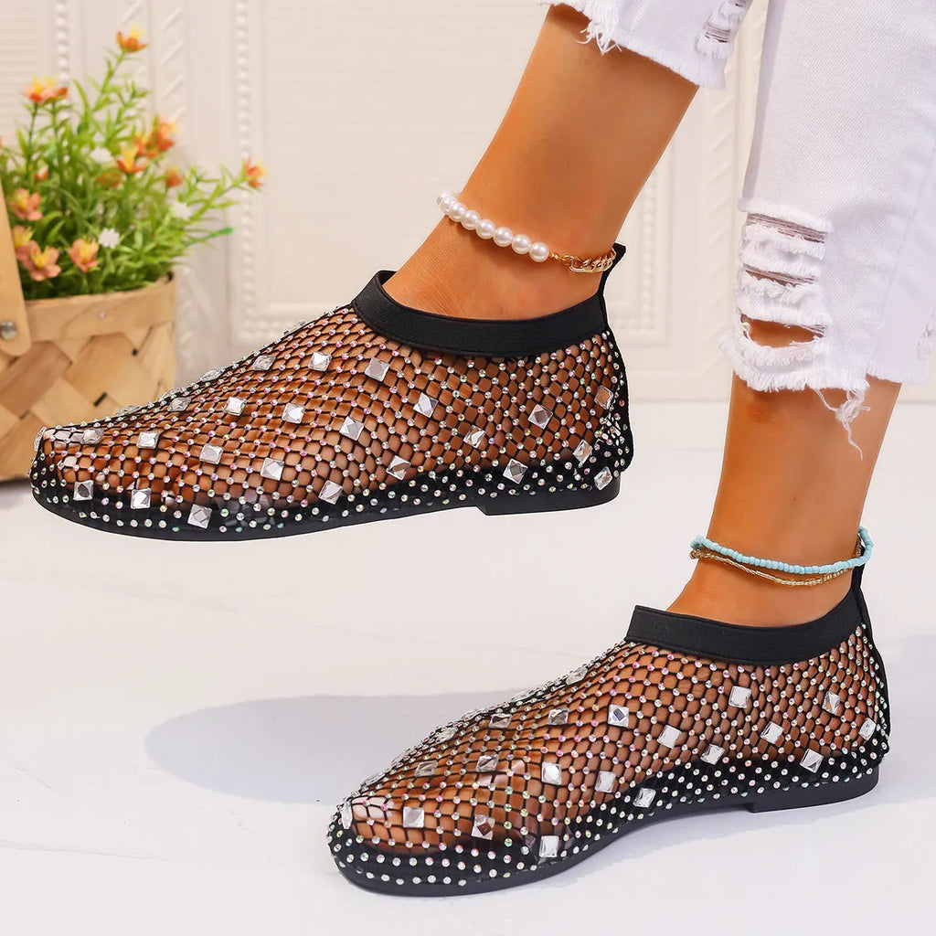 Women's white mesh flat sandals with colourful rhinestone decoration and a rubber sole.