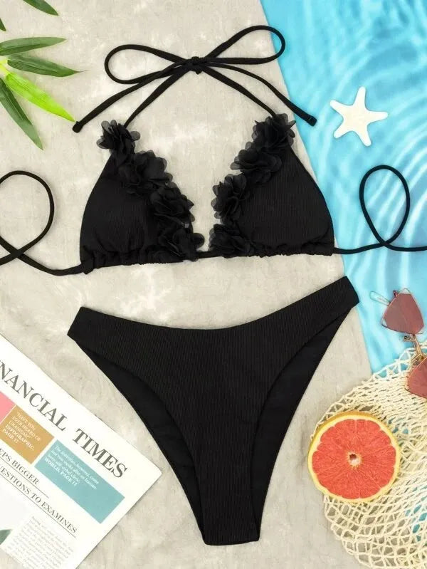Black gathered style women's bikini top and shorts swimwear set on a mannequin