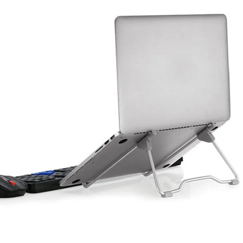 Grey aluminium and plastic universal stand holding a mobile phone and a laptop on a desk