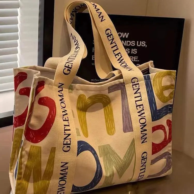 Large capacity canvas tote bag showing three design options: black letters, coloured letters, and pattern print